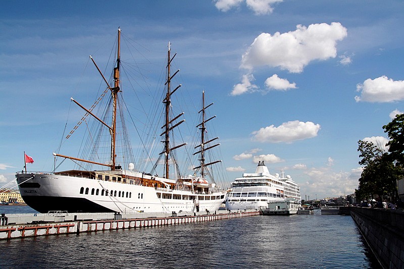 Cruise ships and sailing ships moored off the English Embankment in Saint-Petersburg, Russia