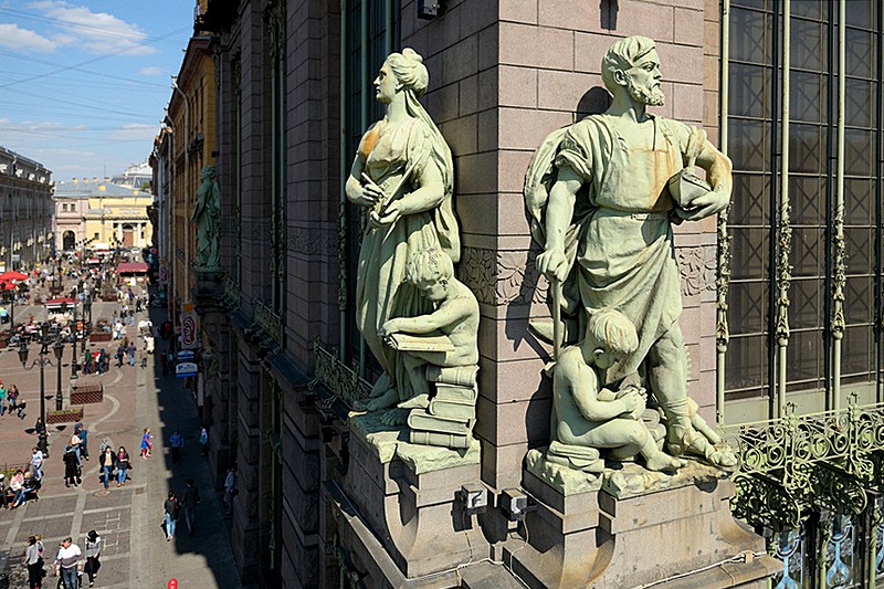 A sculpture on the facade of the Eliseev Emporium and a view of Malaya Sadovaya Ulitsa in St Petersburg, Russia