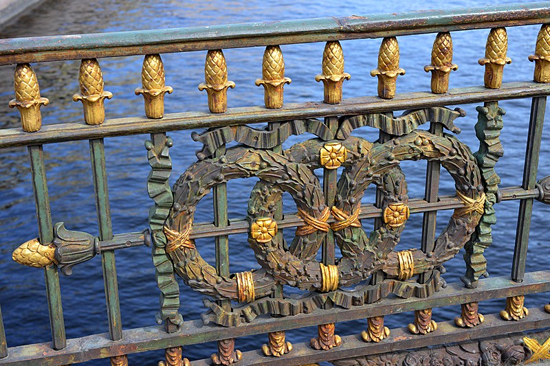 Wrought-iron railing of Bolshoy Konyushenny Bridge over the Moyka River in St Petersburg, Russia