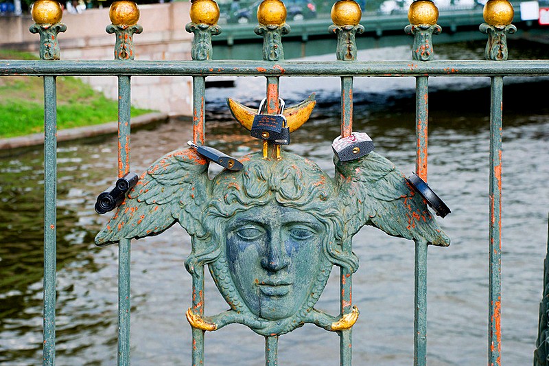 Wrought-iron railings of Maly Konyushenny Bridge over the Moyka River in Saint-Petersburg, Russia