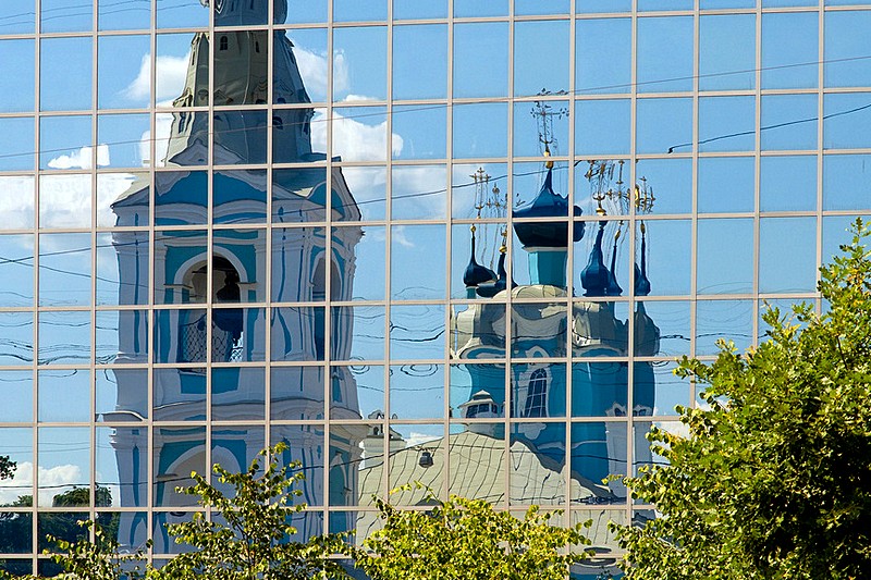 Domes of St. Sampson (Sampsonievskiy) Cathedral reflected in mirror windows across the street in St Petersburg, Russia