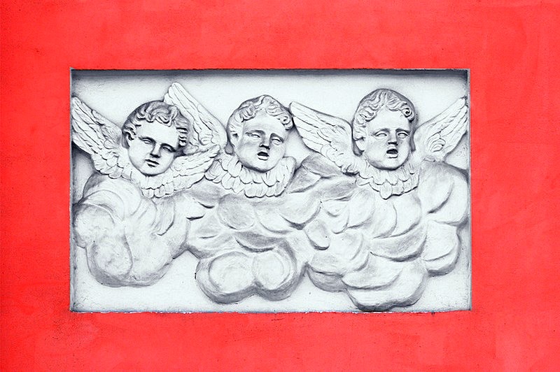 'Three cherubs' bas-relief on the wall of the church in St Petersburg, Russia