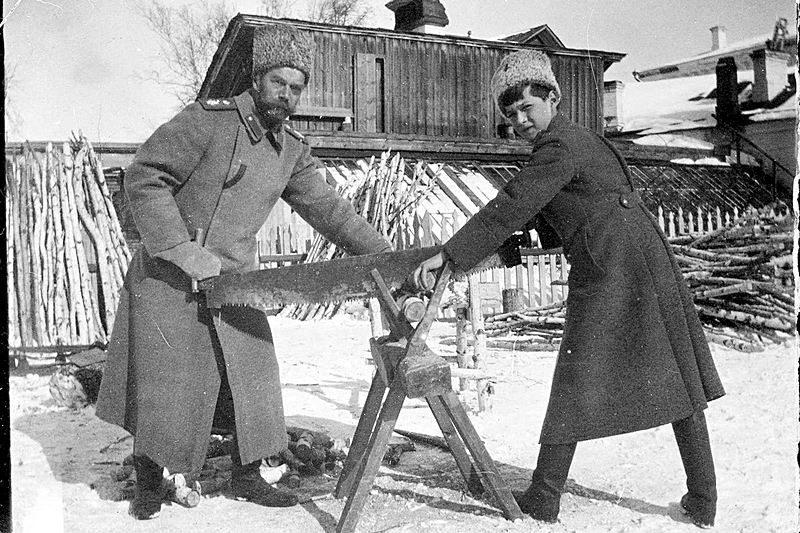 Snapshot by Grand Duchess Maria Nikolaevna of Nicholas II and Tsarevich Alexey Nikolaevich sawing wood at Tobolsk in 1917