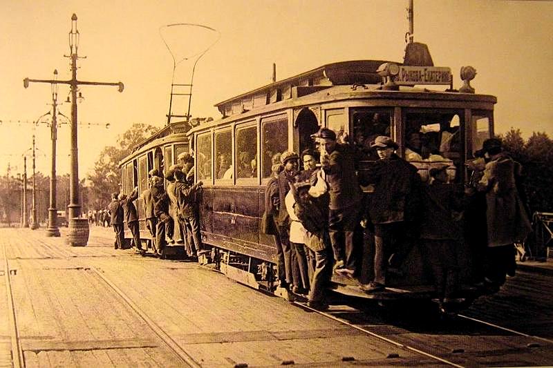 A crowded MS+PS trams with tram surfers on Troitsky Bridge, Leningrad, 1933, Russia