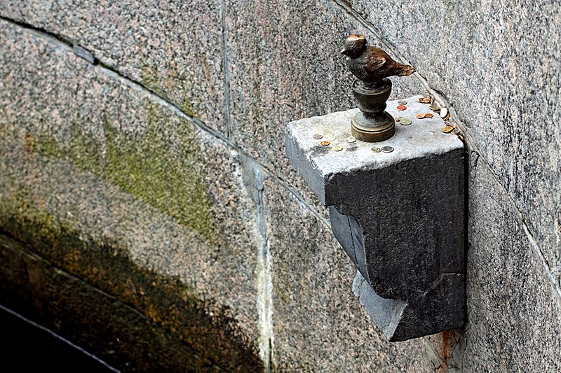 Chizhik-Pyzhik - statue of a songbird on the Fontanka River Embankment in St Petersburg, Russia