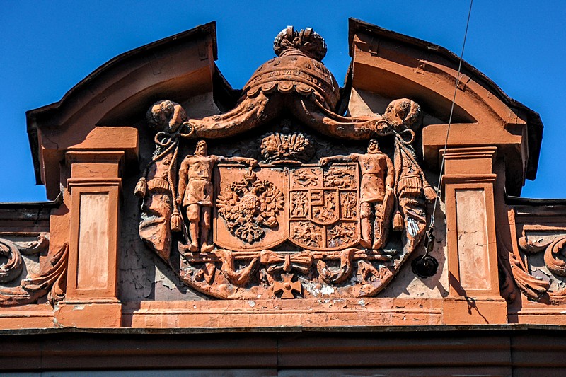 Old family crest on the pediment of the Palace of Grand Duchess Olga Alexandrovna (Baryatinsky Mansion) in Saint-Petersburg, Russia