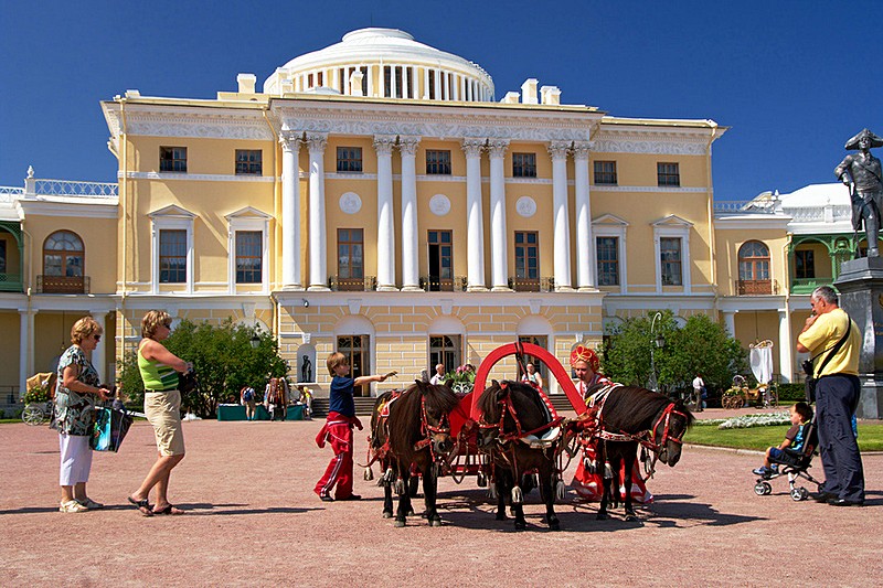 Riding in three-horse carriages in Pavlovsk royal estate, south of St Petersburg, Russia